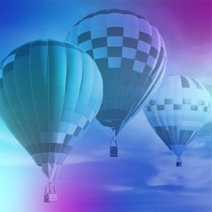 A blue and purple gradient over a picture of three hot air balloons in the sky